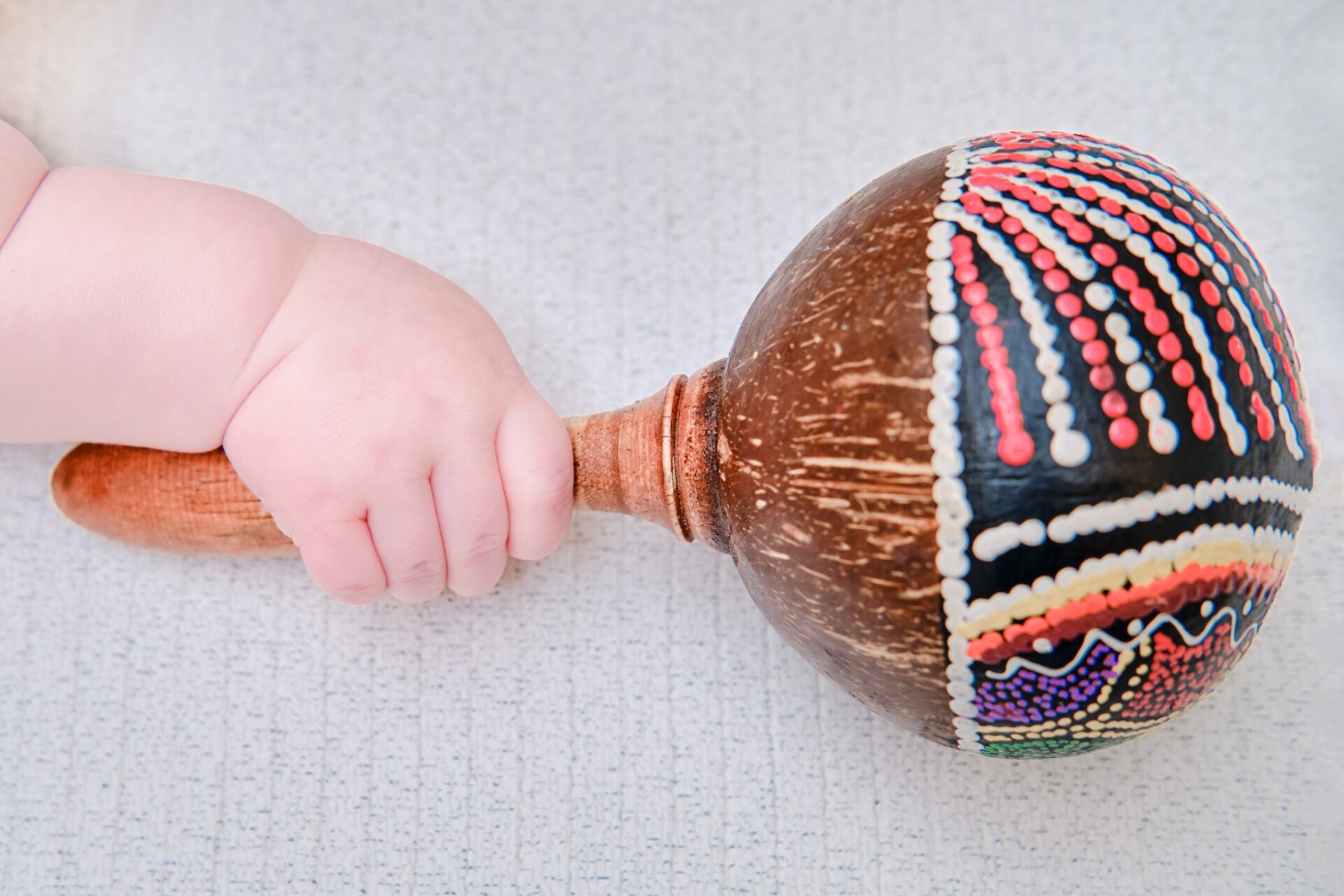 54395349-baby-hand-and-percussion-musical-instrument-close-up